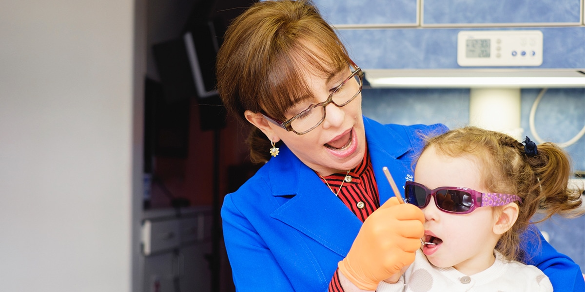 Parent brushing infant's teeth